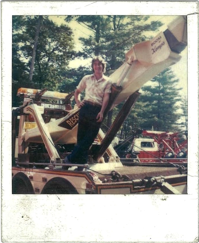 Vintage polaroid of man standing on a wrecker